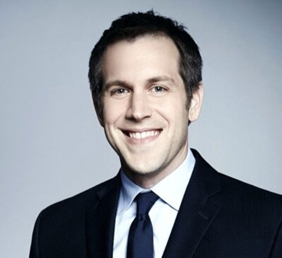 Jordy Jones poses with her laptop and her son on her lap.