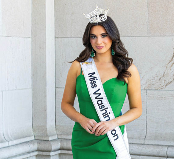 A woman jumps and cheers in a crowd of students